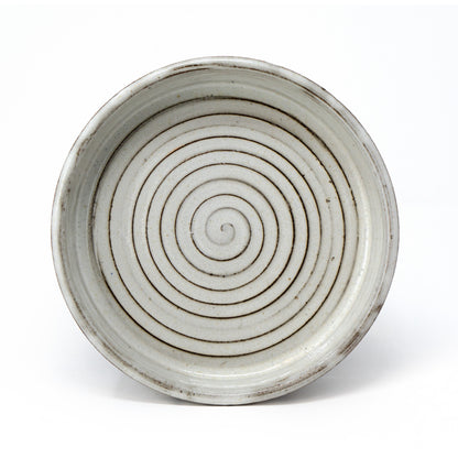 white and brown swirl dish by a hill studio