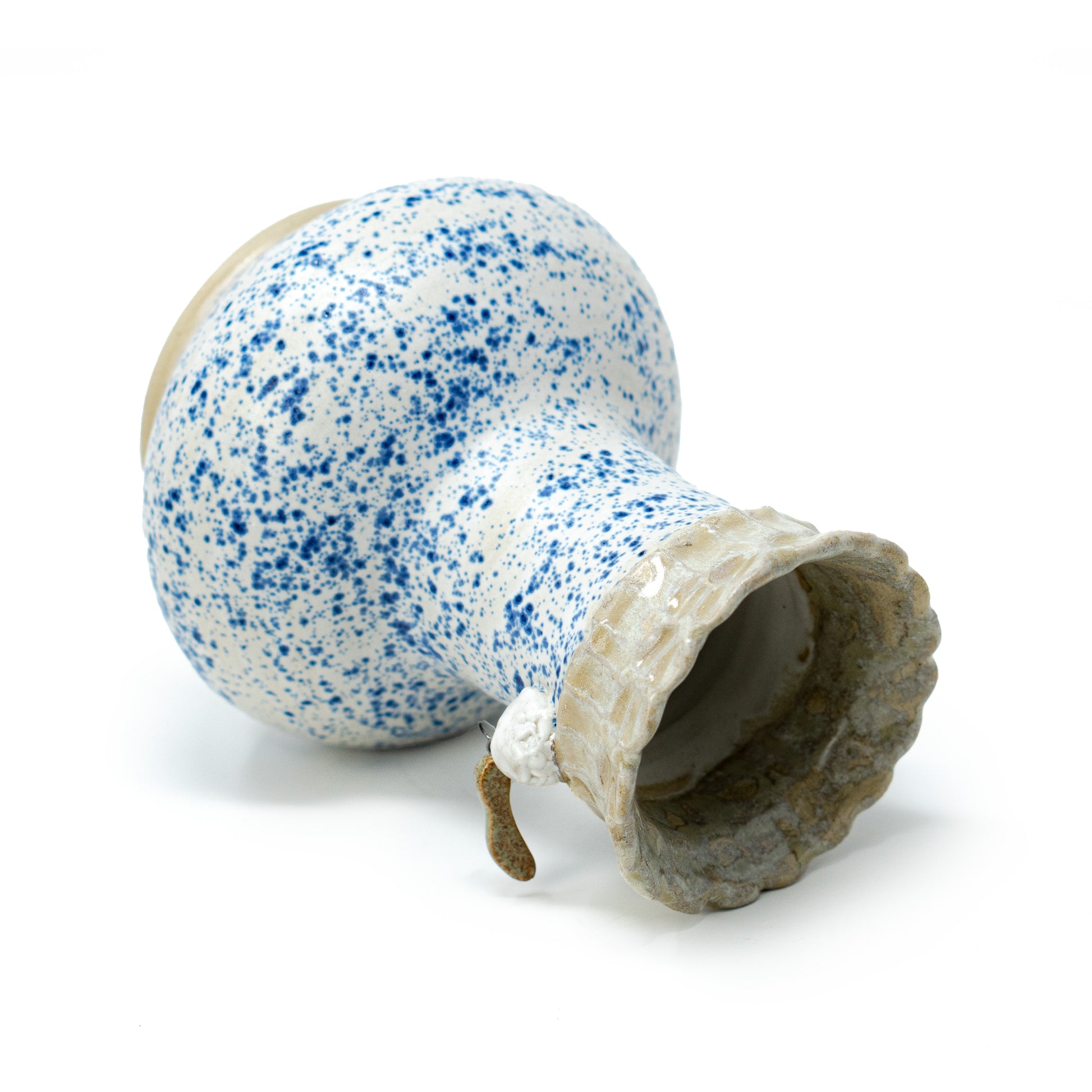 side shot of white and blue speckled ceramic vase by a hill studio