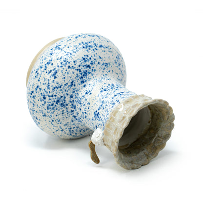 side shot of white and blue speckled ceramic vase by a hill studio