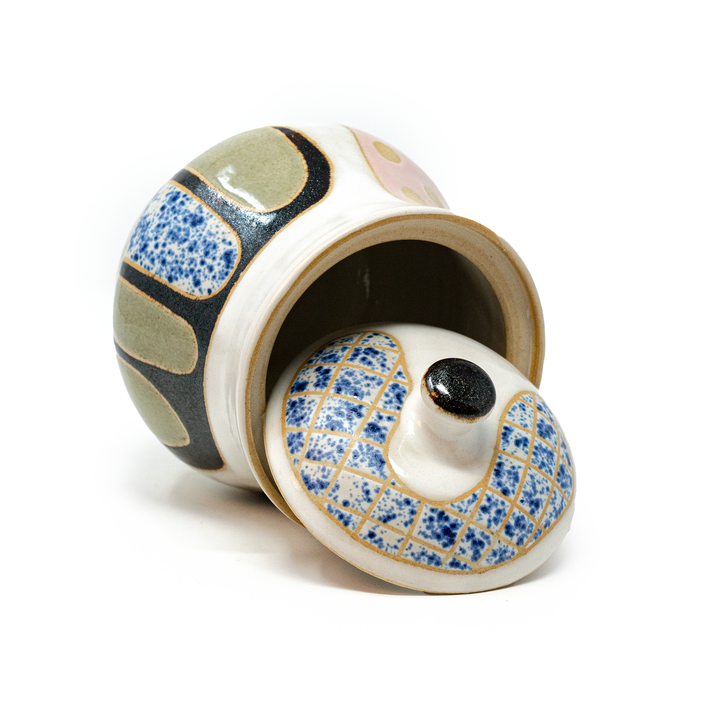 handmade ceramic jar on side with lid