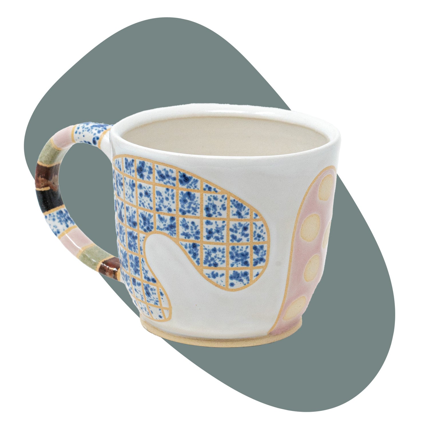 white mug with abstract designs on shaped background