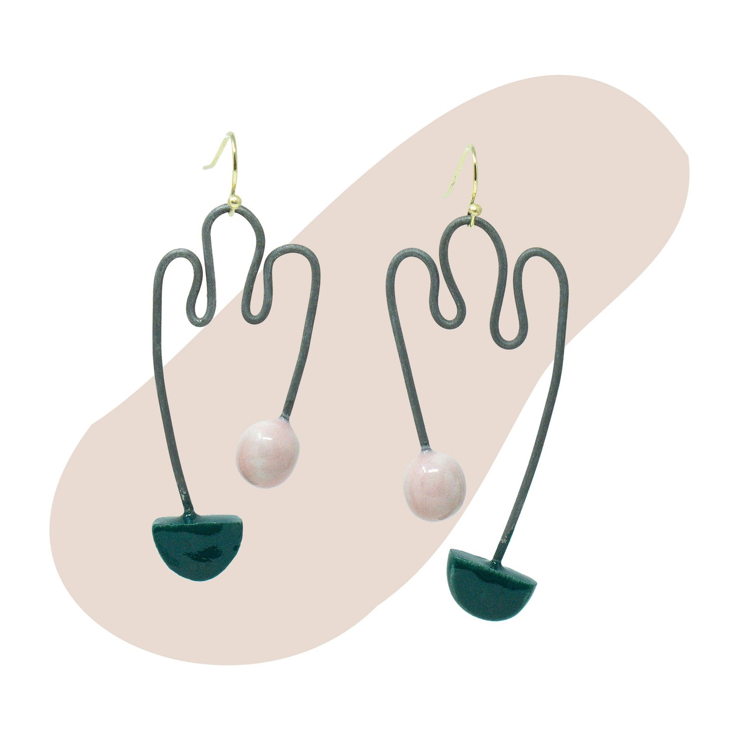 a pair of earrings on shaped background
