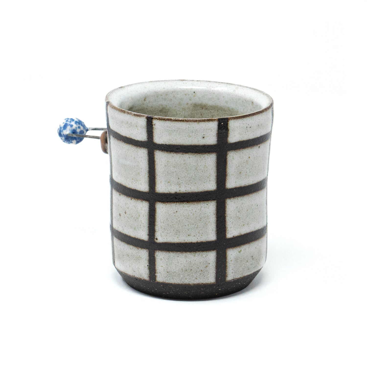 Handmade ceramic Checker Mug by A Hill Studio with black grid pattern and blue accent bead handle