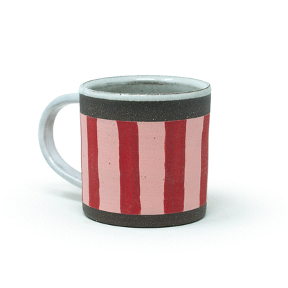 spinning Ceramic mug with red and pink striped design on a white background