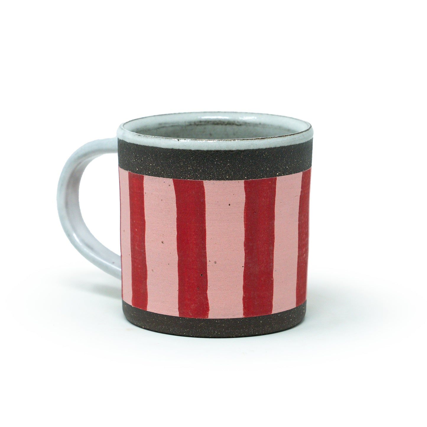 Ceramic mug with red and pink striped design on a white background