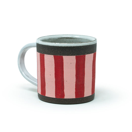 Ceramic mug with red and pink striped design on a white background