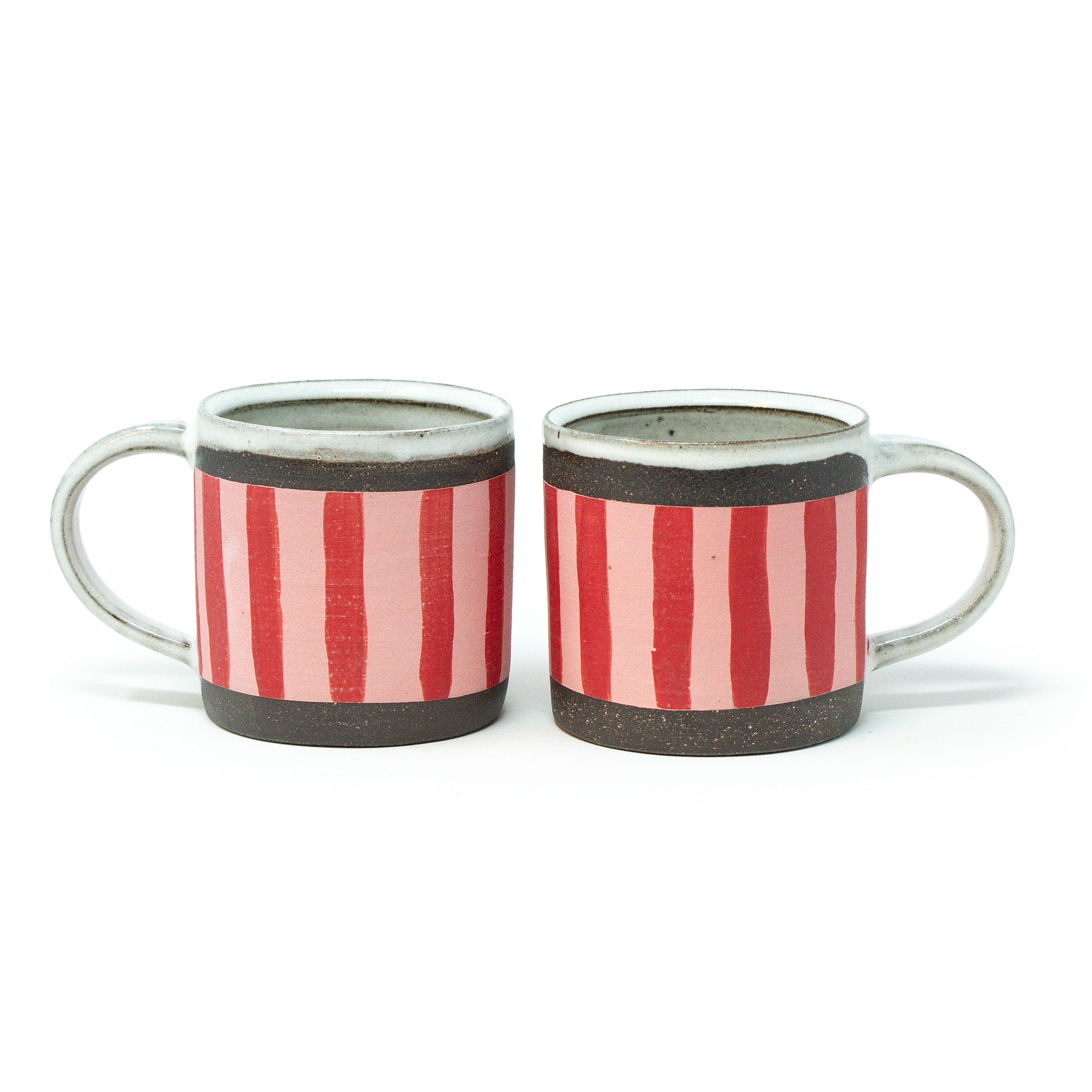 Two ceramic mugs with red and white striped design on a white background