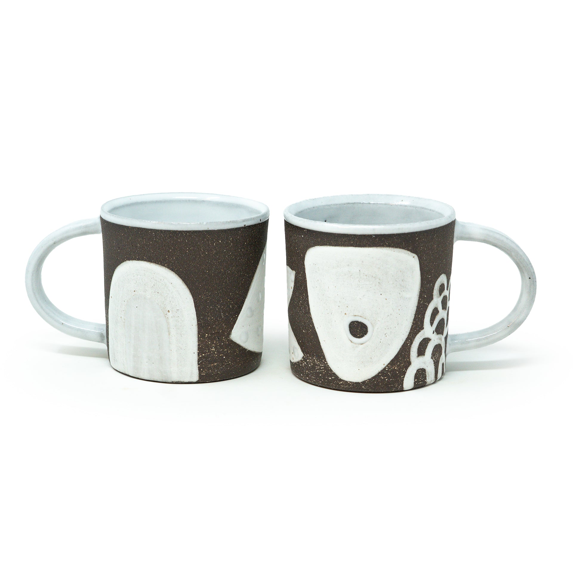 two winter solstice mugs side by side 